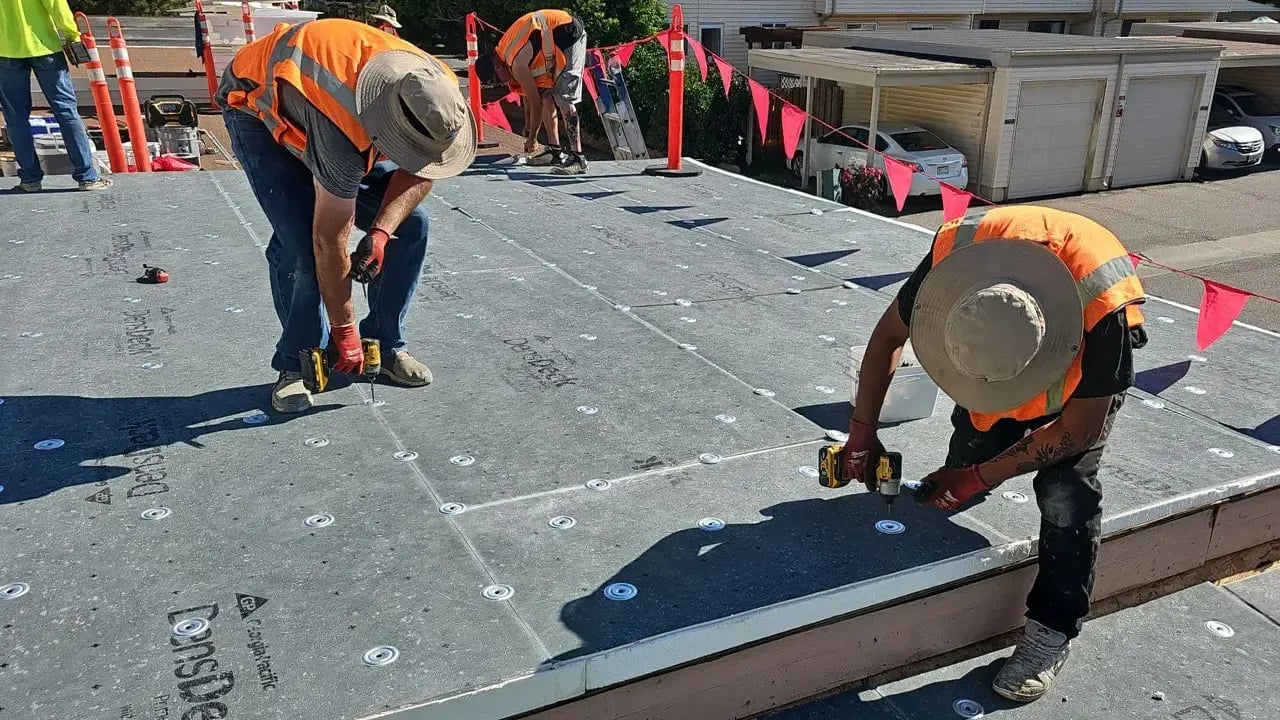 Excel Roofing Crew Installing a Flat roof for a HOA community