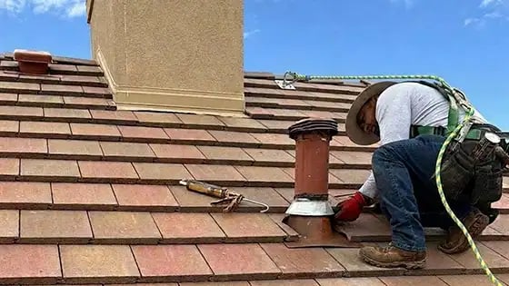 Expert Excel Roofing Repair Technician Raul Reparing Flashing on A Terra Cotta Concrete Tile Roof-3
