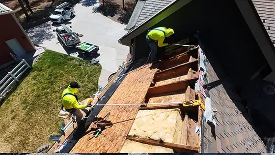 Expert Excel Roofing repair technicians work on a roof with improper attic ventilation 