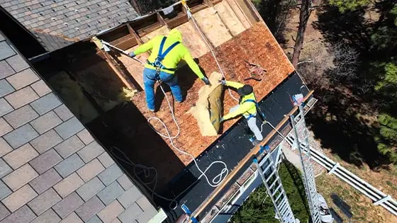 Two men fixing a roof condensation problem