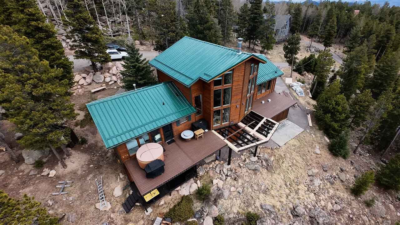 Green PBR roof on a conifer CO mountain home