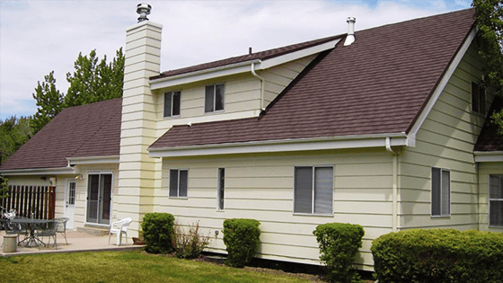 Home with a brown stone coated steel roof