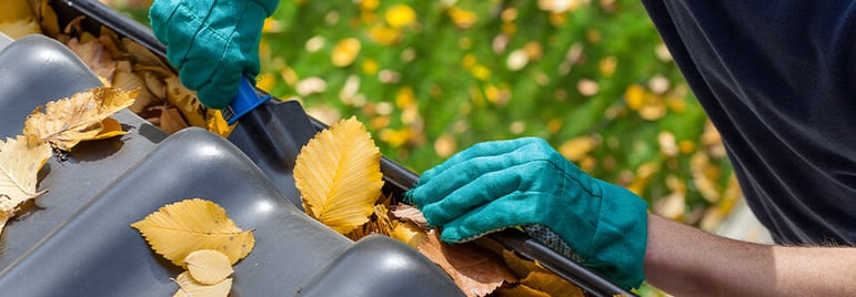 man cleaning gutters