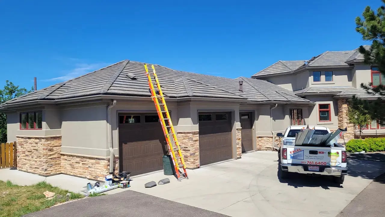 Tan concrete tile roof recently installed by Excel Roofing