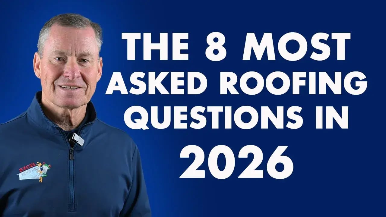 J Bretz of Excel Roofing in a blue half zip long sleeve shirt, ready to answer homeowner questions about roofing