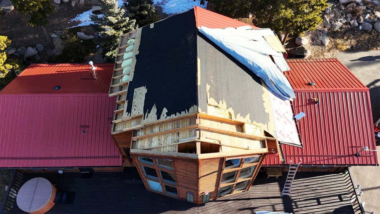 The Taylor's red metal roof on their colorado mountain home, ripped off by 100mph winds right before christmas