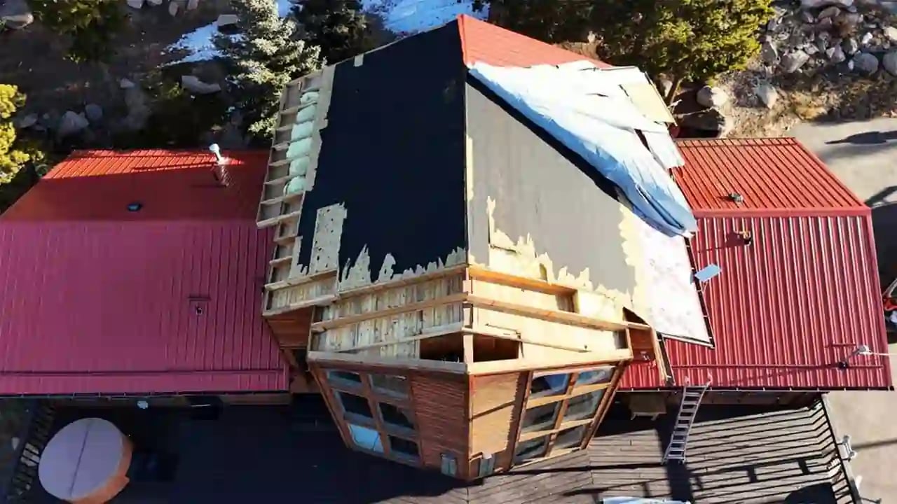 The Taylor's red metal roof on their colorado mountain home, ripped off by 100mph winds right before christmas