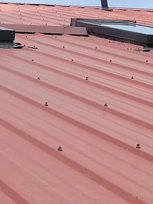 red propanel metal roof with exposed fasteners