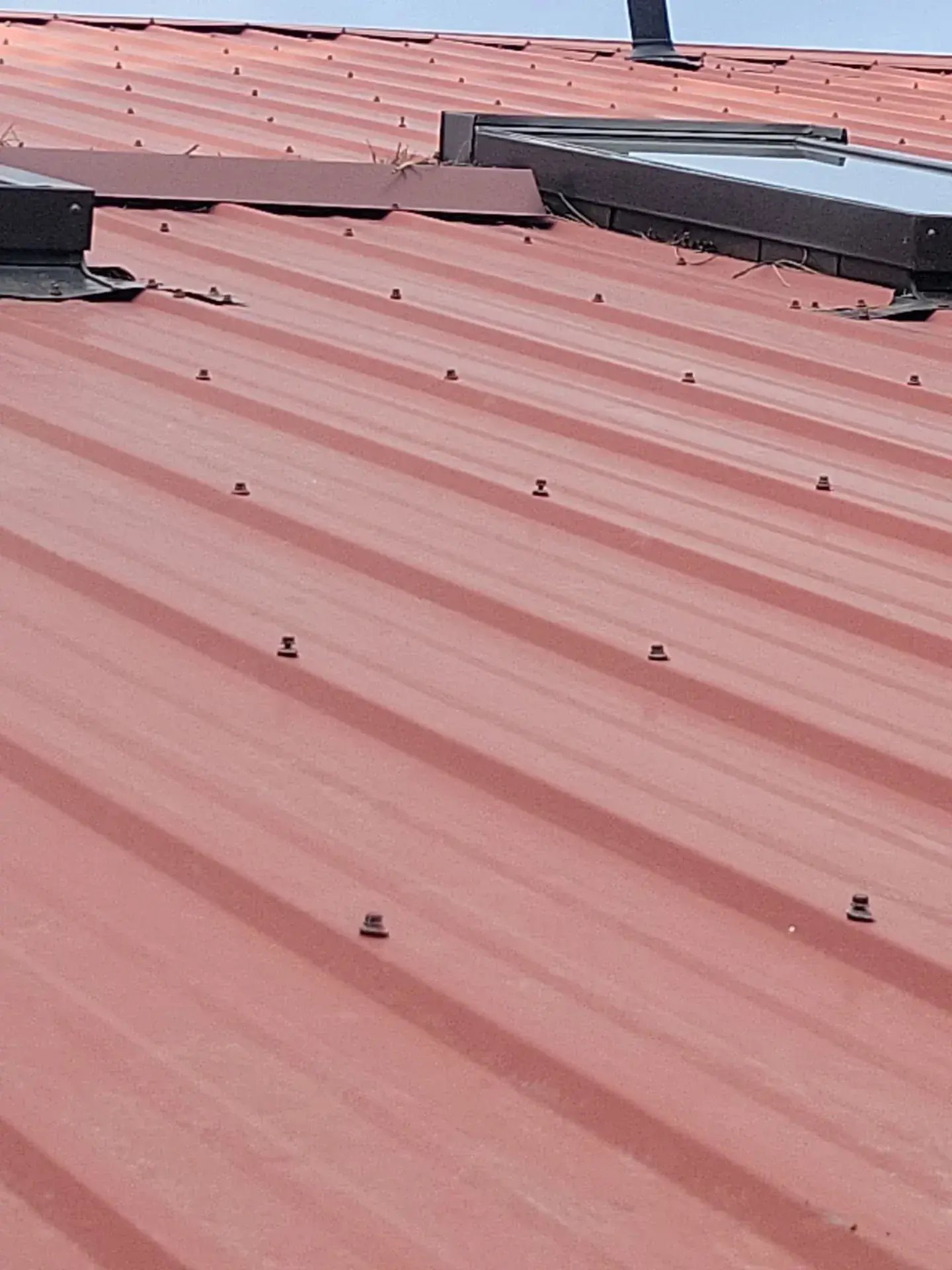 red propanel metal roof with exposed fasteners