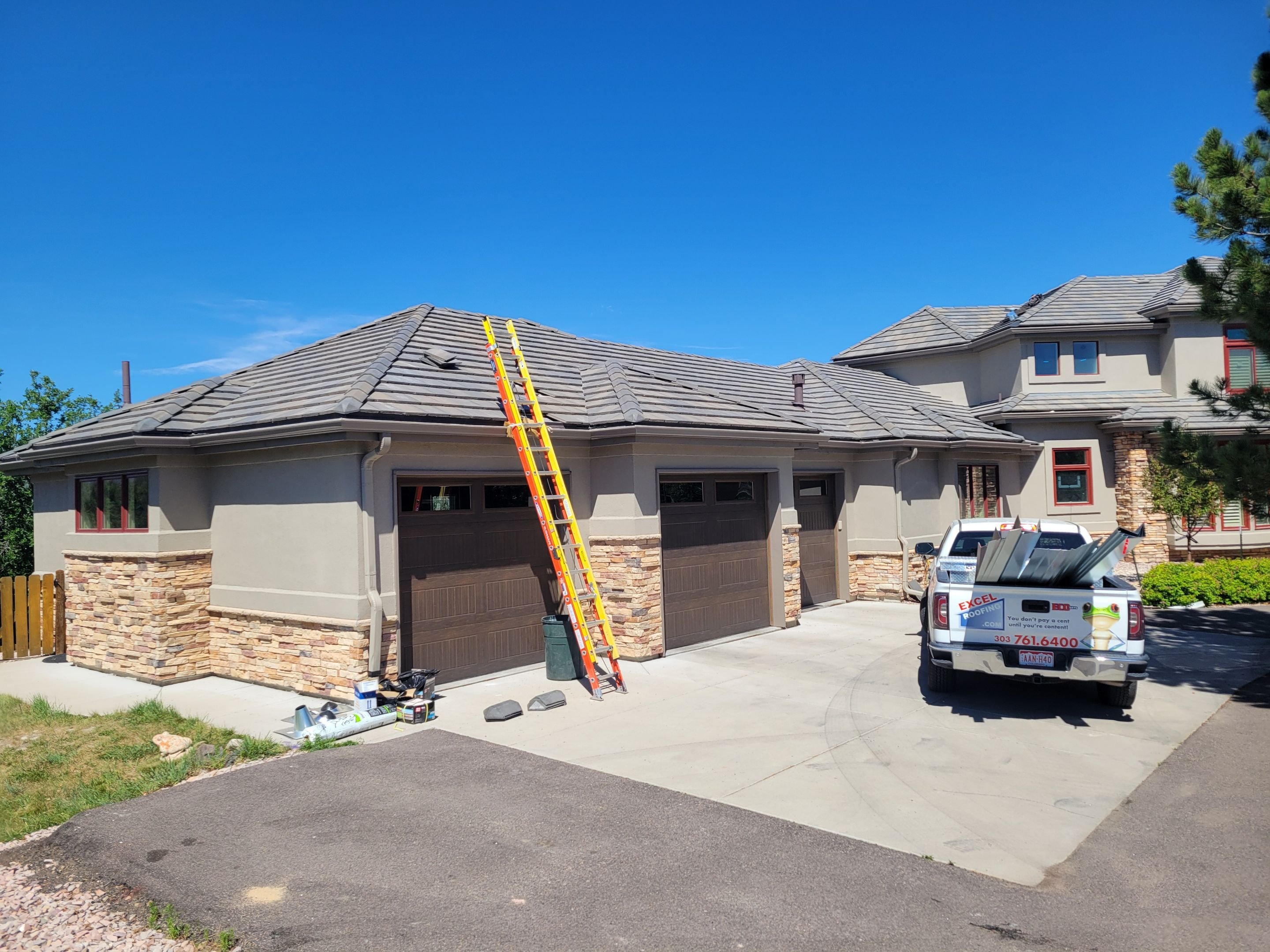 Excel Roofing crew replacing the roof on a residential investment property