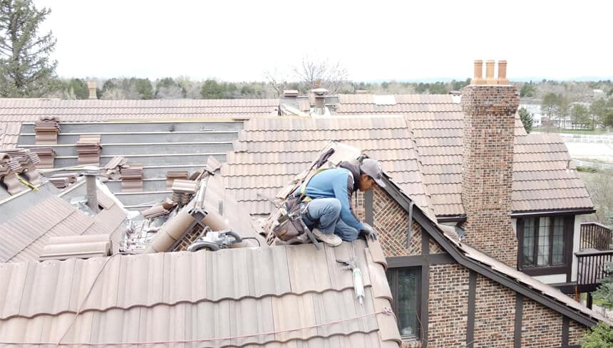 A Excel Roofing roofer replacing class 4 tile on a roof