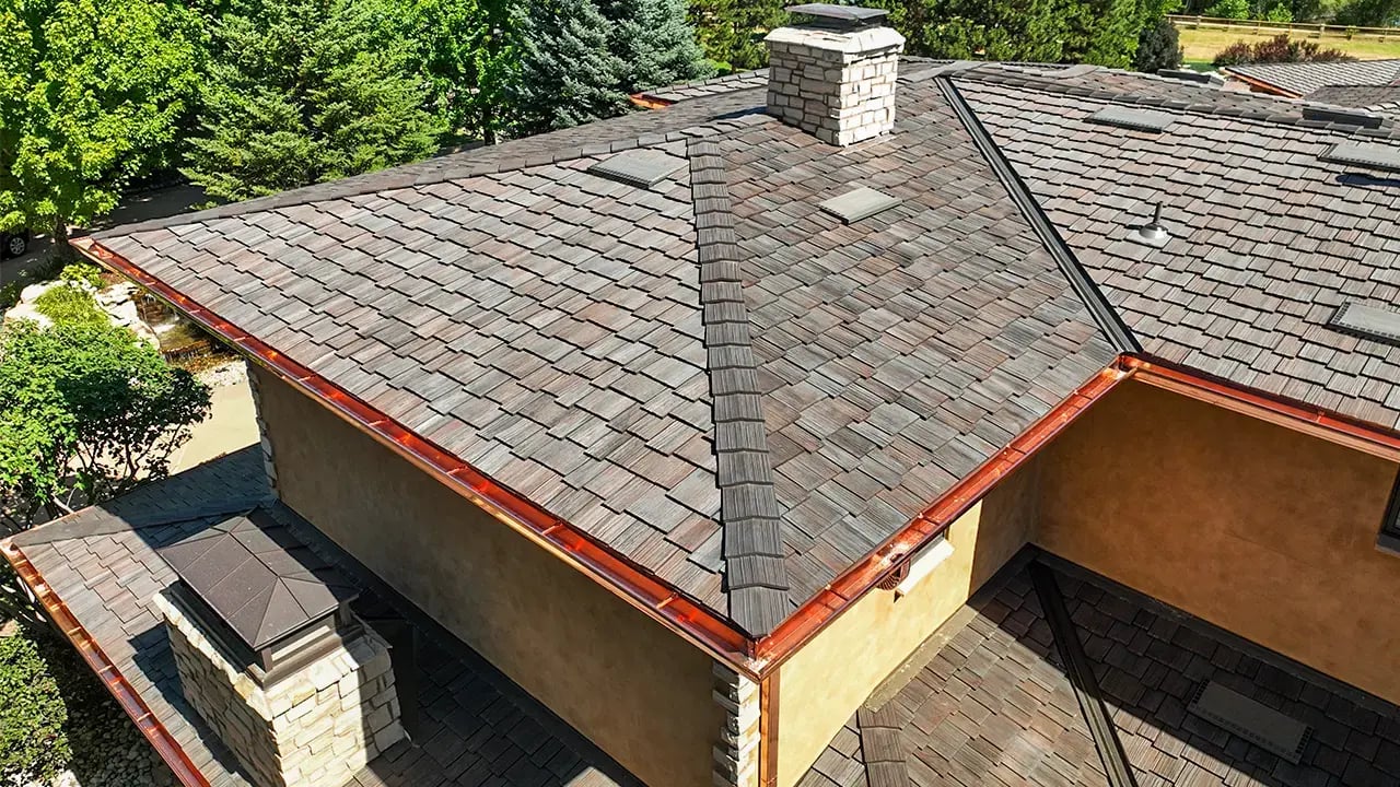 copper gutters on a beautiful cherry hills home with a brava synthetic shake roof