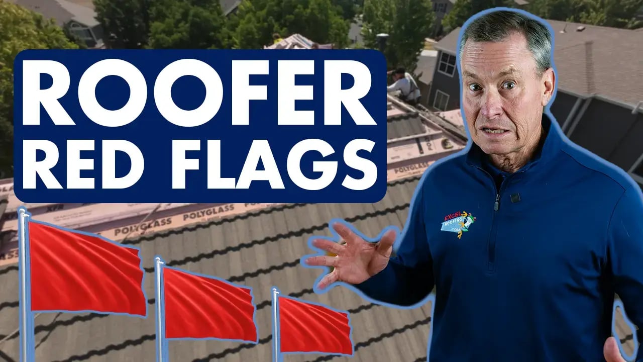 J Bretz in front of a home with a stone-coated steel roof being installed, being hassled by some red flags