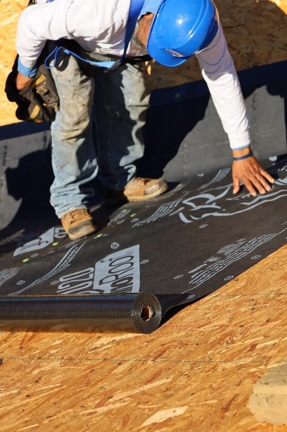 Expert Excel Roofing roofer placing ice and water shield for an asphalt shingle roof