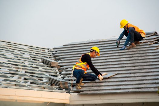 Two Excel Roofing Roofers installing a concrete tile roof