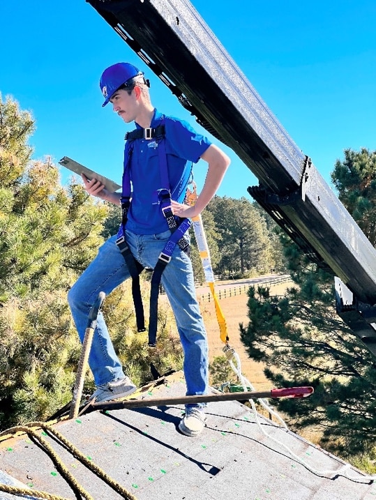 worker-standing-on-top-of-roof